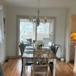 Dining room interior painting in Philadelphia with white walls, wood floors, and modern lighting.