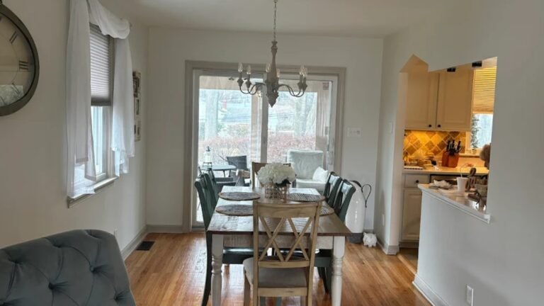 Dining room interior painting in Philadelphia with white walls, wood floors, and modern lighting.