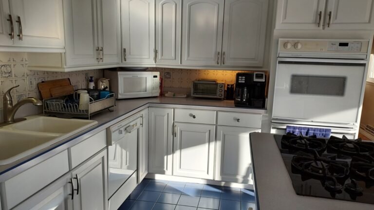 Modern white kitchen with freshly painted cabinets and updated finishes