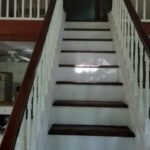 Freshly painted interior staircase with white risers and dark wood steps in Philadelphia home