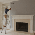 Interior house painter applying fresh paint in a Philadelphia home living room.